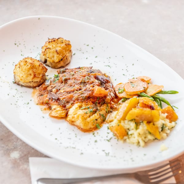 Happy Days Finer Diner's chicken with tomato sauce, roasted potatoes, carrots, green beans, and risotto.