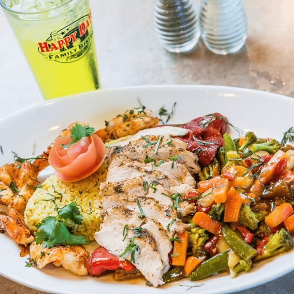 Happy Days Finer Diner's grilled chicken and shrimp with rice, vegetables, and a drink.