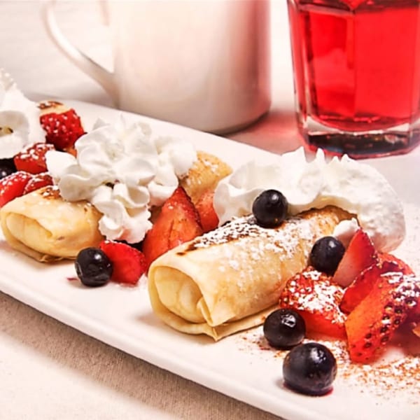 Happy Days Finer Diner crepes with whipped cream, strawberries, blueberries, and powdered sugar.