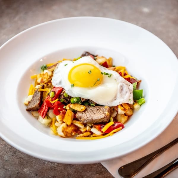 Happy Days Finer Diner's steak and egg breakfast hash with peppers, onions, and cheese.