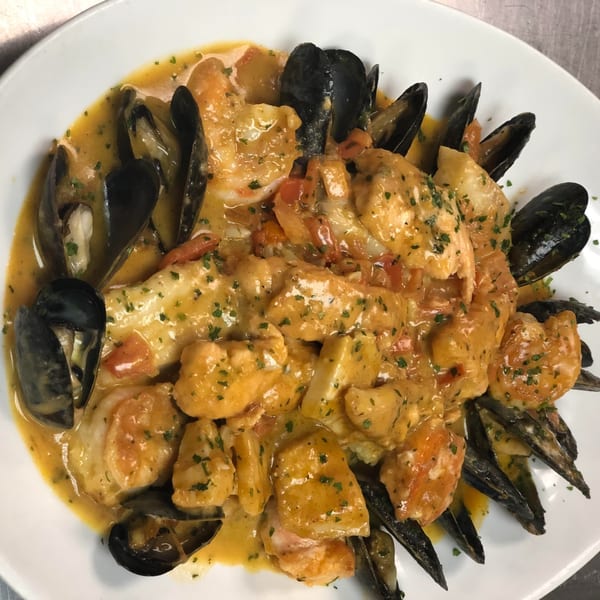 Happy Days Finer Diner's seafood dish with mussels, shrimp, and fish in a creamy sauce.